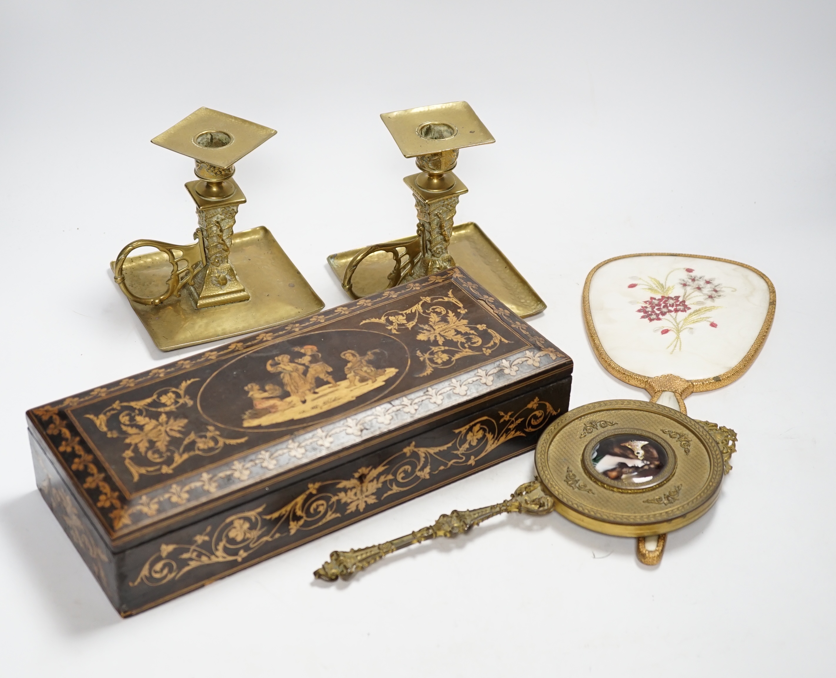 An inlaid Sorrento style box, a gilt hand mirror with enamel cartouche, a pair of brass candle holders and another hand mirror, box 30cm wide